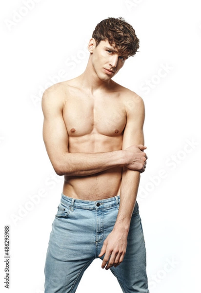 Fototapeta Portrait of sexy man in jeans isolated on white background