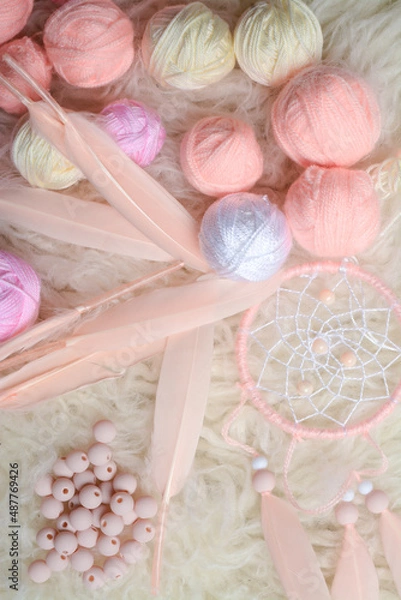 Fototapeta Handmade vintage dream catcher and small balls of yarn on soft white background