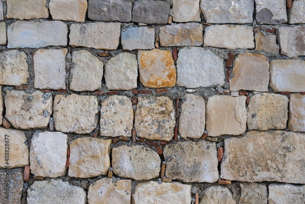 Fototapeta The texture of the stone wall. Background texture of the stone wall of the old castle.