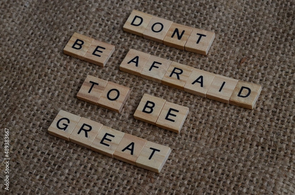 Fototapeta don't be afraid to be great text on wooden square, motivation and business quotes