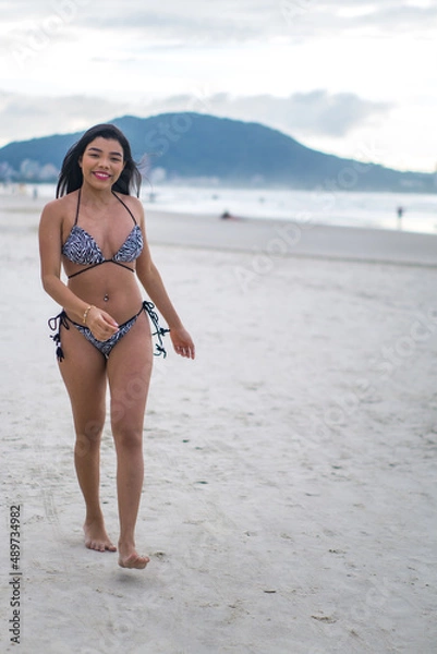 Fototapeta young beautiful and happy Asian Indonesian woman in bikini enjoying holidays at tropical beach in Bali enjoying holidays and travel