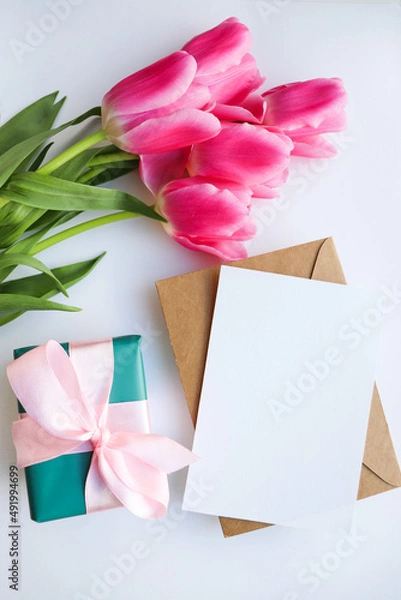 Fototapeta beautiful bouquet of pink tulips and a gift box with a pink bow 