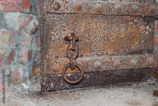 Fototapeta Rusty metal door in an old fort.