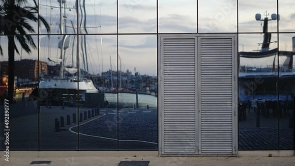 Fototapeta sidewalk with glass facade on harbor