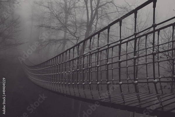 Fototapeta View of a suspension bridge in the fog