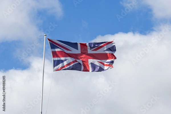 Fototapeta Union Jack flag of United Kingdom flyiing with ripped edges