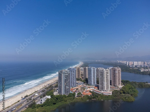 Fototapeta Amazing seaside town in the middle of the mountains with a river flowing - drone aerial view - Barra da Tijuca, Rio de Janeiro, RJ, Brazilian Beach