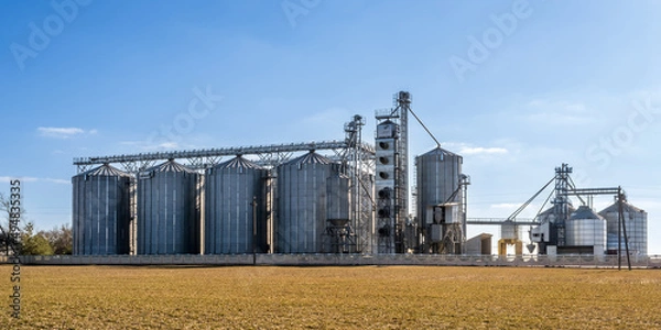 Fototapeta panorama view on agro silos granary elevator on agro-processing manufacturing plant for processing drying cleaning and storage of agricultural products, flour, cereals and grain.