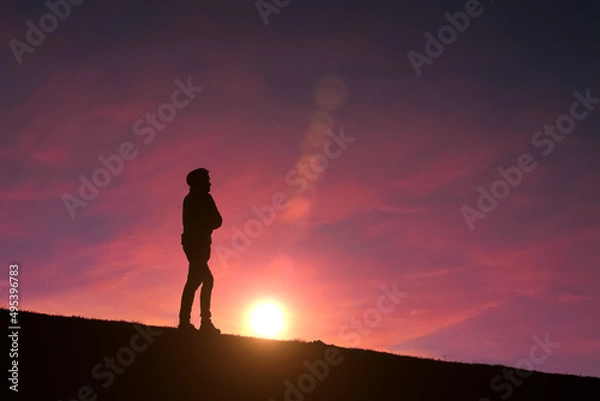 Fototapeta adult man silhouette in the mountain with a romantic sunset background