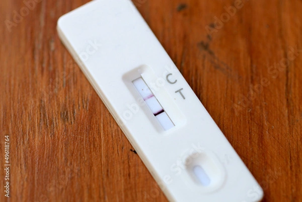 Fototapeta Antigen Test kit with Positive result during swab COVID-19 testing. Coronavirus Self nasal or Home test, Lockdown and Home Isolation concept.