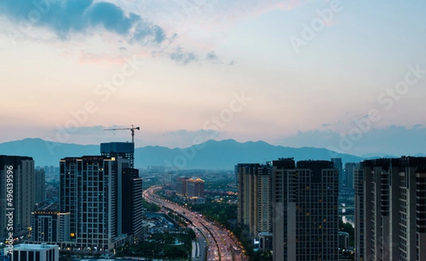 Fototapeta Modern skyscrapers in the city at dusk