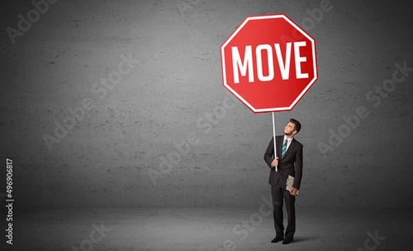 Fototapeta Young business person holding road sign