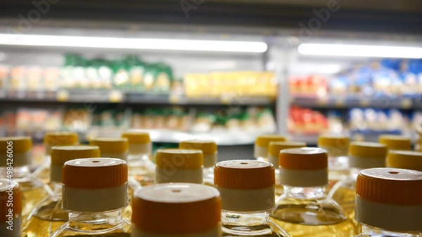 Fototapeta Close-up of many sunflower oil bottles on a store shelf