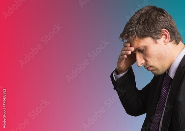 Fototapeta Caucasian businessman holding his head against copy space on blue and pink gradient background