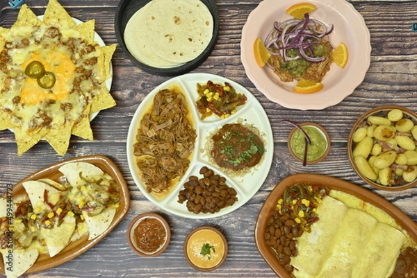 Fototapeta mexican food with fajitas, chili con carne and nachos with avocado, beef and cheese