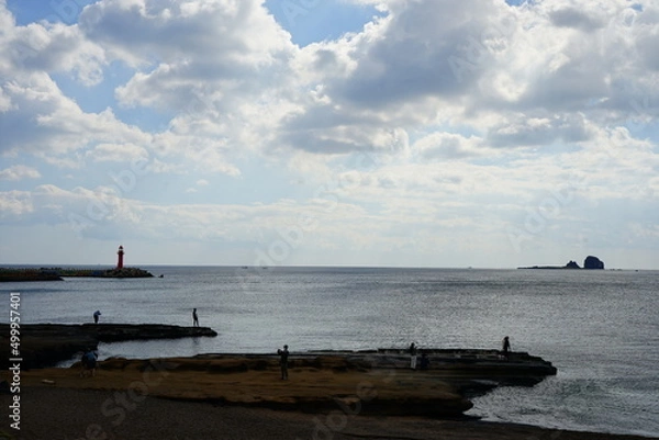 Fototapeta fascinating rock beach and island, with charming clouds