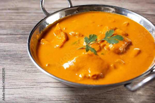 Fototapeta A view of fish curry, in a karahi bowl.