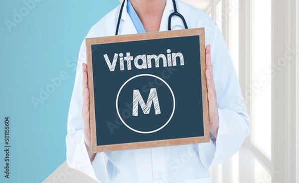 Fototapeta Vitamin M - Doctor shows information on blackboard.Doctor holding chalkboard with text.