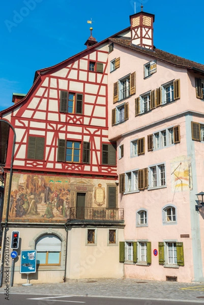 Fototapeta Historical tenement house (apartment building) with facade paintings and half timbered walls in an old town in Swiss city Stein am Rhein in Switzerland 
