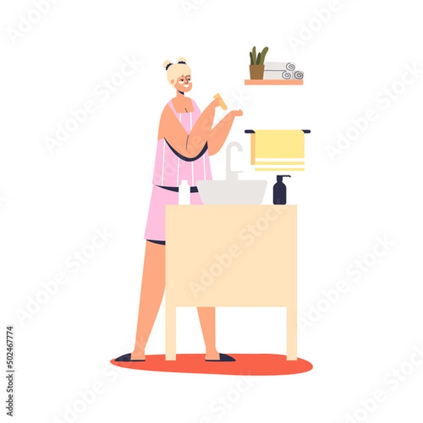 Fototapeta Young woman applying skincare cream lotion on face in front of mirror for night skin treatment