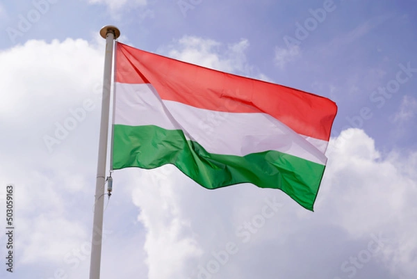 Fototapeta flag hungaria National state flag hungary on wind mat with blue cloud sky