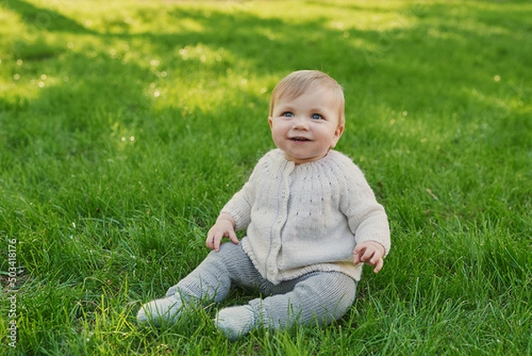 Fototapeta Smiling baby boy on grass in park. Children Protection Day. World Children's Day