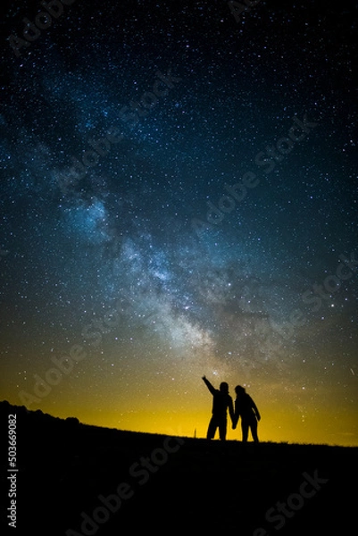 Fototapeta Milky way and couple in Serra Del Montsec, Lleida, Spain