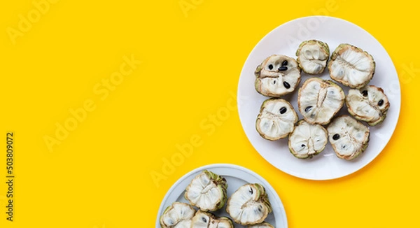 Obraz Custard apple on yellow background.