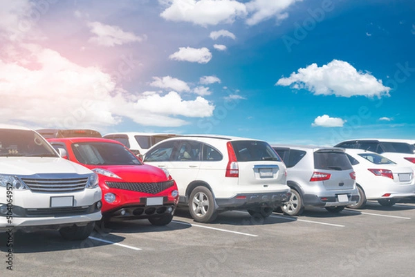 Fototapeta Cars parking in a row in stock background. Car vehicle transportation trip inventory merchandise, horizontal.