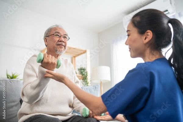 Fototapeta Asian older aged man doing physiotherapist with support from nurse. 