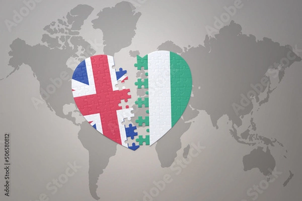 Fototapeta puzzle heart with the national flag of nigeria and great britain on a world map background. Concept.