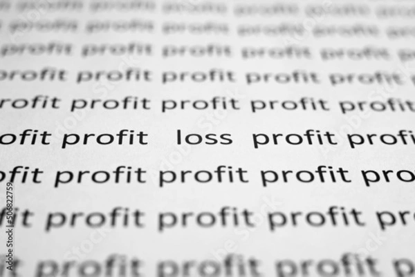 Fototapeta Financial problems, economic crisis concept. Printed text profit and loss on white paper close-up. Selective focus on word Loss, low angle view, macro photo