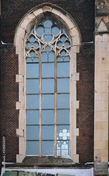 Fototapeta Elongated vintage vertical window on the facade of the building. Baroque and Gothic architecture. Church of St. Olga and Elizabeth. Lviv, Ukraine.