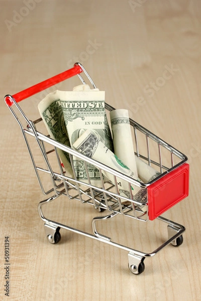 Fototapeta Money in cart on wooden table close-up