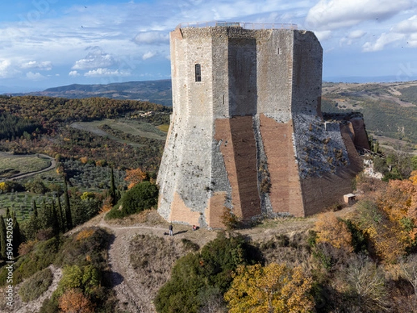 Fototapeta Medieval fortification castle on hilltop and view on hills in Tuscany, Italy