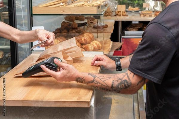 Fototapeta payment with the card for a purchase in the bakery store - retail sales concept