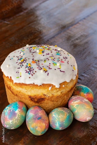 Fototapeta Easter cake with multicolored Easter eggs. Bright packaging. Preparations for Easter. Festive cakes with white glaze