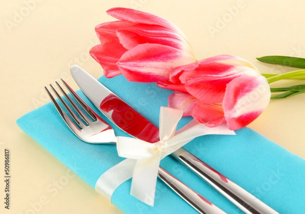 Fototapeta Festive dining table setting with tulips on beige background