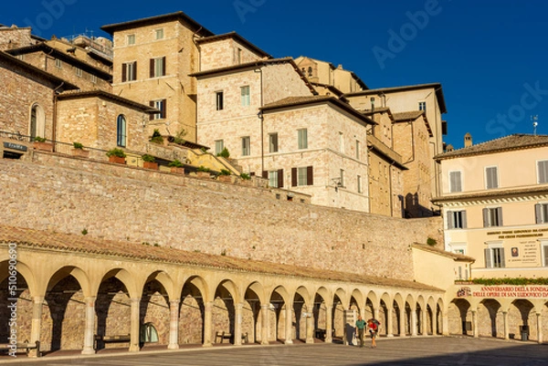 Fototapeta ASSISI, ITALY, 6 AUGUST 2021 Historic buildings next to the church