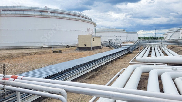 Fototapeta Petrochemical tank farm with pipelines