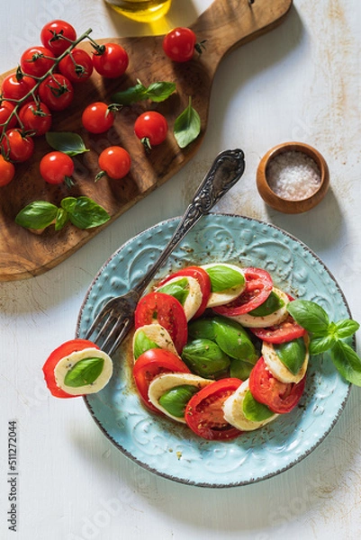 Fototapeta Fresh Italian Caprese Salad on Wooden Background