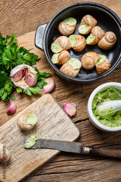 Fototapeta Preparing baked snails with garlic and parsley