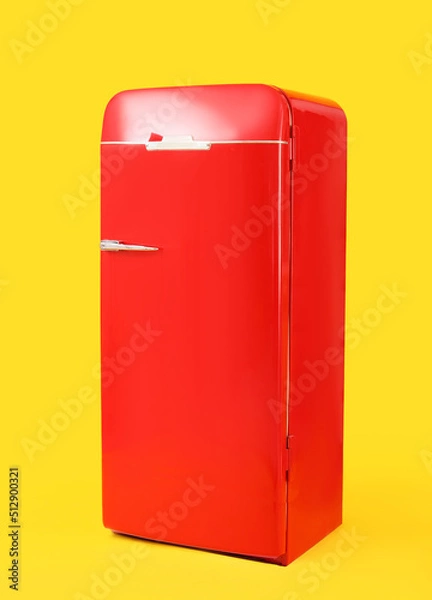 Fototapeta Stylish retro fridge on yellow background