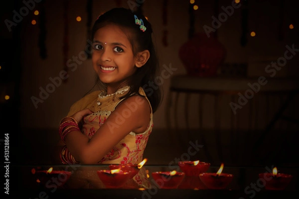 Fototapeta Happy girl standing arm crossed during Diwali festival night