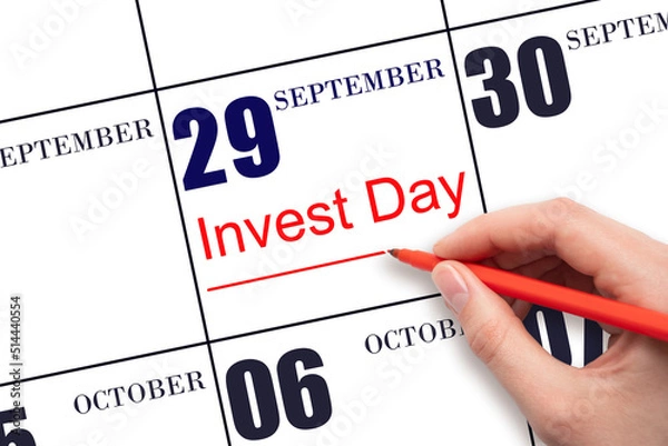 Fototapeta Hand drawing red line and writing the text Invest Day on calendar date September 29. Business and financial concept.