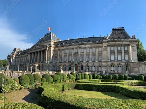 Fototapeta Front facade of The Royal Palace of Brussels. It is  is the official palace of the Belgian Royal family in the city centre. Belgian flag is waiving on top of the building. Bruxelles, Belgium