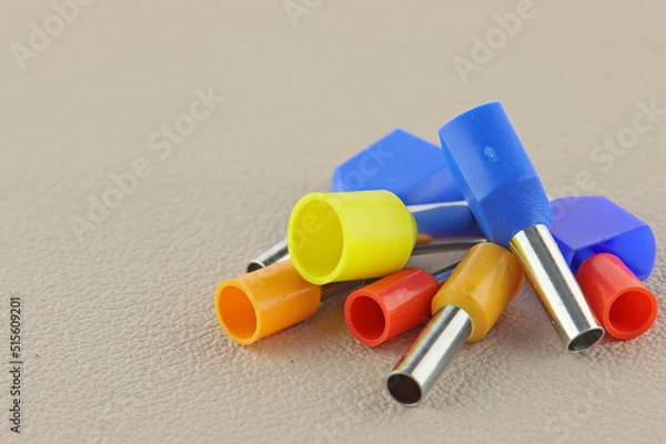 Obraz Coloured crimp terminals for different wire sizes. Copper sleeves for crimping electrical cables. Ferrules. Selective focus, copy space