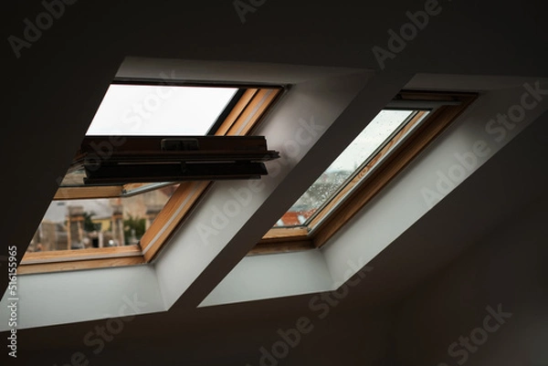 Fototapeta rain on skylights in bright bedroom. scandinavian style in the interior