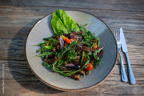 Fototapeta Fresh vegetable salad of tomatoes, cucumbers, italian mix, lettuce.