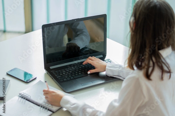 Fototapeta Businesswoman uses her laptop in a co-working office